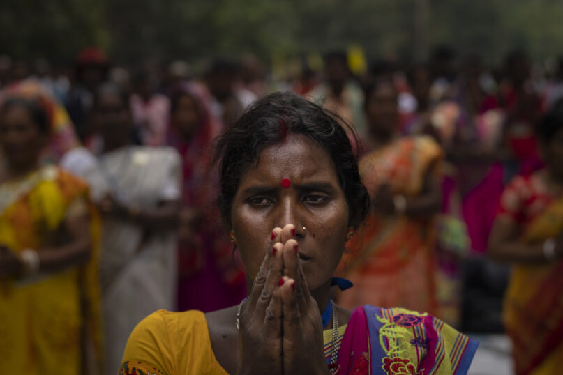 A tribes woman prays during a sit-in demonstration rally to demand of recognizing Sarna Dharma as a religion in Ranchi, capital of the eastern Indian state of Jharkhand, Oct. 18, 2022. Tribal groups have held protests in support of giving Sarna Dharma official religion status in the run-up to the upcoming national census, which has citizens state their religious affiliation. (AP Photo/Altaf Qadri)