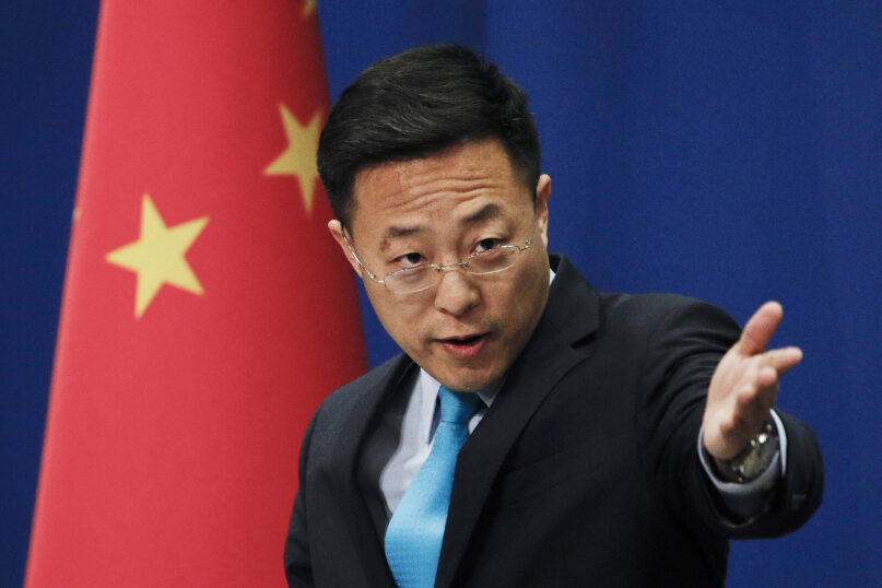 FILE - Chinese Foreign Ministry spokesperson Zhao Lijian gestures as he speaks during a daily briefing at the Ministry of Foreign Affairs office in Beijing on Feb. 24, 2020. Beijing and the Vatican are once again tangling over the prickly issue of appointing Chinese bishops. After complaints from the Vatican that Beijing was violating a 2018 interim accord, China’s Foreign Ministry spokesperson on Monday, Nov. 28, 2022 said the country is willing to expand the “friendly consensus” achieved with the Vatican over bishop nominations. (AP Photo/Andy Wong, File)