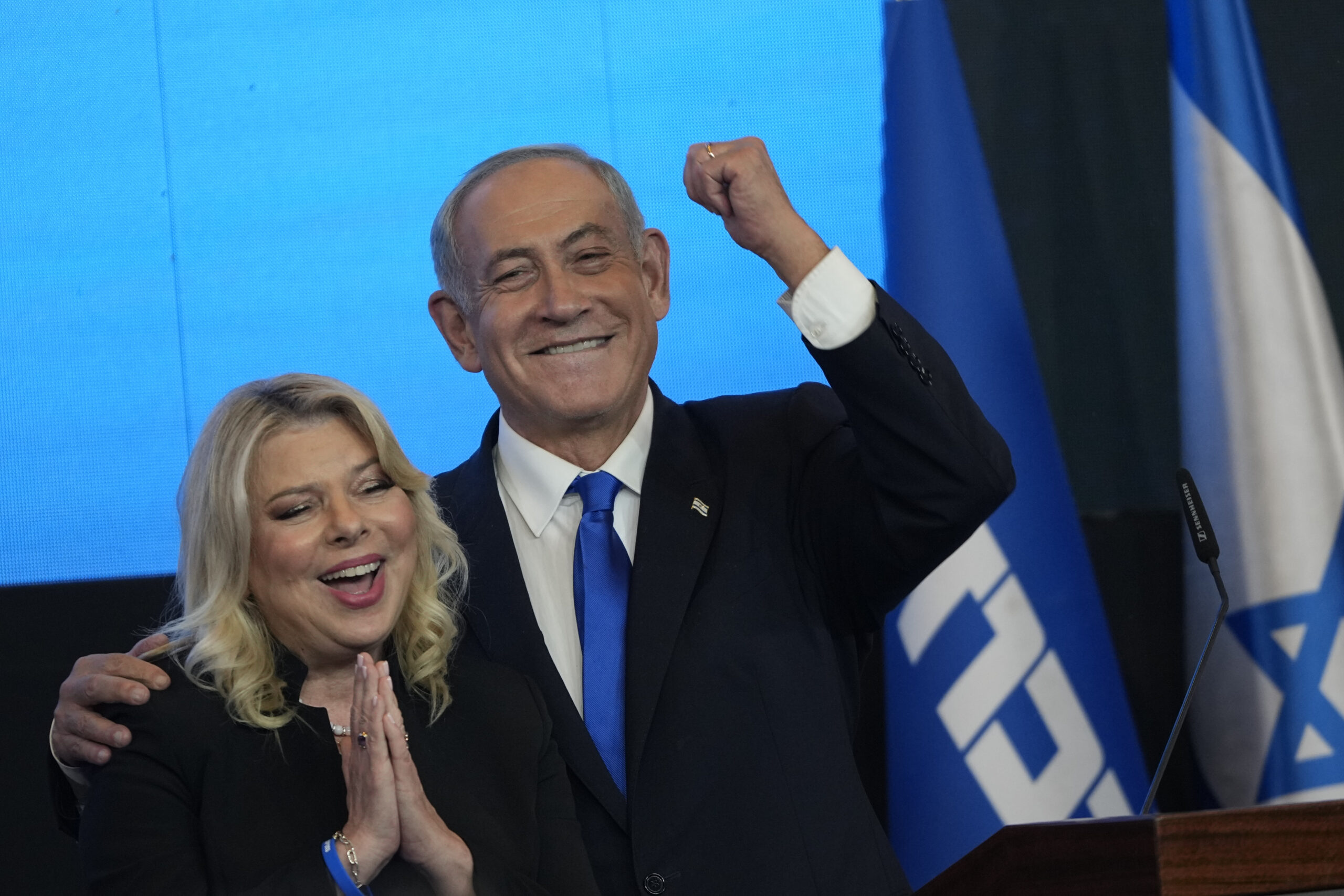 Former Israeli Prime Minister and the head of Likud party, Benjamin Netanyahu and his wife Sara gesture after first exit poll results for the Israeli Parliamentary election at his party's headquarters in Jerusalem, Wednesday, Nov. 2, 2022. (AP Photo/Tsafrir Abayov)