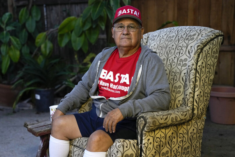 Ron Flores, a Republican, sits on his porch, Thursday, Nov. 3, 2022, in Huntington Beach, Calif. Flores is retired and helps campaign for conservative candidates. (AP Photo/Ashley Landis)