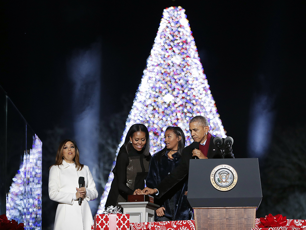 President Barack Obama, first lady Michelle Obama and their daughter Sasha light the 2016 National Christmas Tree during the National Christmas Tree lighting ceremony at the Ellipse near the White House in Washington, Thursday, Dec. 1, 2016. Also on stage is the host Eva Longoria. (AP Photo/Pablo Martinez Monsivais)