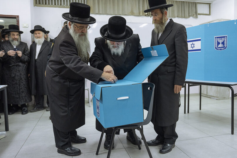 Ultra-Orthodox Jews watch Rabbi Israel Hager vote during Israel elections in Bnei Brak, Tuesday, Nov. 1, 2022. Israel held its fifth election in less than four years. (AP Photo/Oded Balilty)