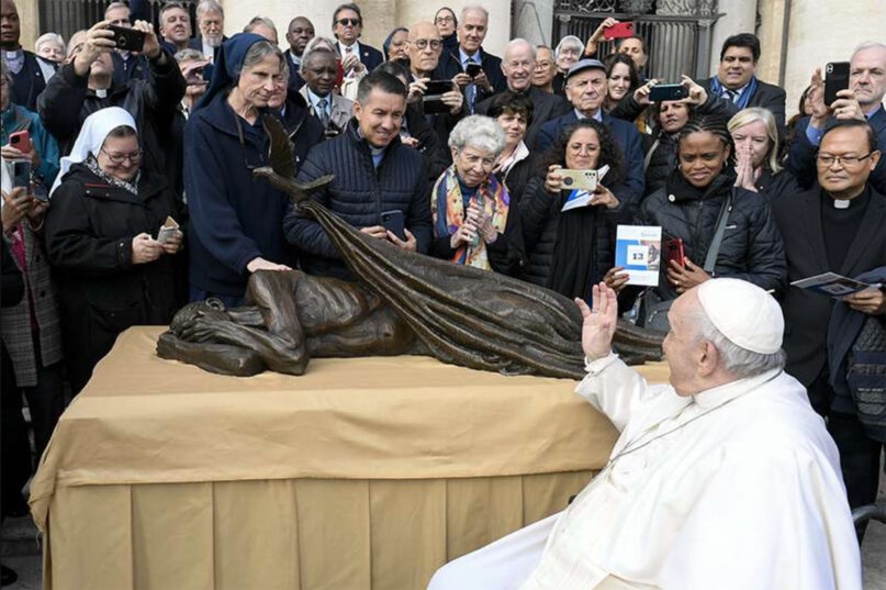 Pope Francis waves to members of Vincentian religious orders and lay communities on Wednesday, Nov. 9, 2022, after blessing Canadian artist Timothy Schmalz's new sculpture, 