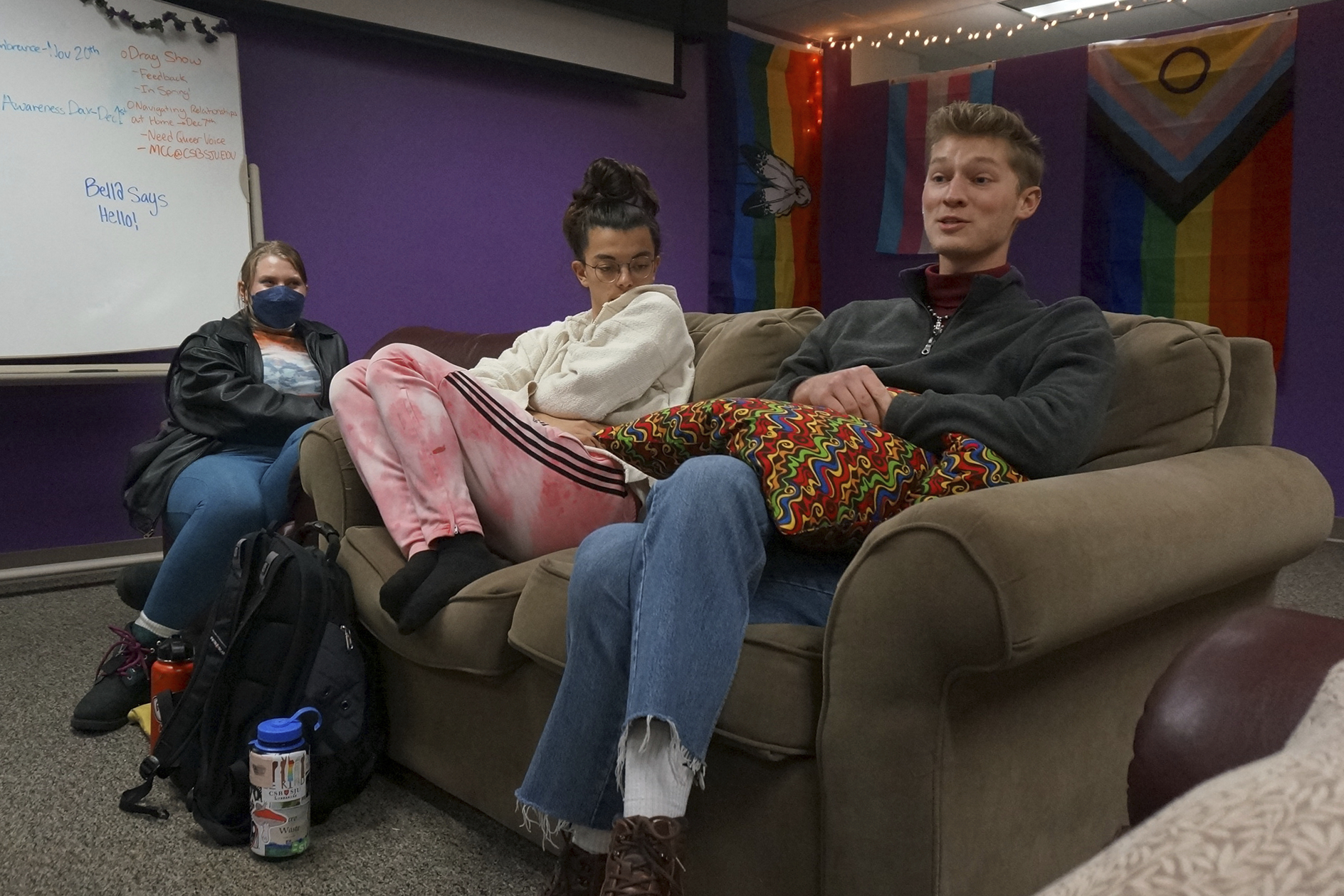 Ryan Imm, Sean Fisher and Sam Schug (from right to left) sit in the dedicated lounge of QPLUS, the LGBTQ student organization for the College of Saint Benedict and Saint John's University for which they serve as coordinators, on the college's campus in St. Joseph, Minn., on Tuesday, Nov. 8, 2022. The three students say they are encouraged by the Catholic institutions' efforts to affirm LGBTQ students like them, such as making QPLUS an official, funded organization from the student club it previously was. (AP Photo/Giovanna Dell'Orto)