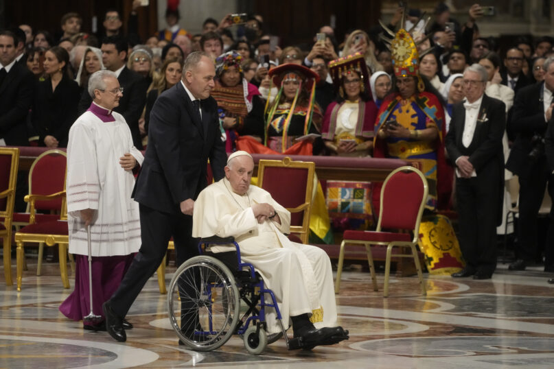 Pope Francis arrives in St. Peter's Basilica at The Vatican to preside over a mass in honor of our lady of Guadalupe, Monday, Dec. 12, 2022. (AP Photo/Gregorio Borgia)