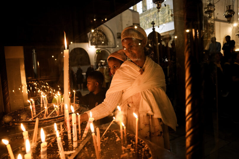 An Ethiopian woman and her child visit the Church of the Nativity, traditionally believed to be the birthplace of Jesus Christ, in the West Bank town of Bethlehem, Saturday, Dec. 3, 2022. Business in Bethlehem is looking up this Christmas as the traditional birthplace of Jesus recovers from a two-year downturn during the coronavirus pandemic. Streets are already bustling with visitors, stores and hotels are fully booked and a recent jump in Israeli-Palestinian fighting appears to be having little effect on the vital tourism industry. (AP Photo/ Mahmoud Illean)