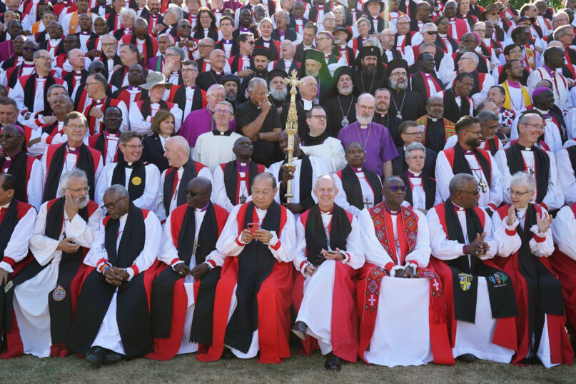 FILE - Archbishop of Canterbury Justin Welby, front row, centre right poses for a photo with bishops from around the world at the University of Kent, during the 15th Lambeth Conference, in Canterbury, England, Friday, July 29, 2022. Friction has been simmering within the global Anglican Communion for many years over its 42 provinces’ sharp differences on whether to recognize same-sex marriage and ordain LGBTQ clergy. In 2022, the divisions have widened, as conservative bishops – notably from Africa and Asia – affirmed their opposition to LGBTQ inclusion and demanded “repentance” by the more liberal provinces with inclusive policies. (Gareth Fuller/PA via AP, File)