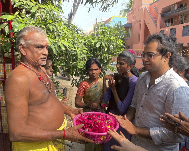 Arjun Viswanathan places his hands on a basket of flowers to be offered to the Hindu deity Ganesh at the Sri Lakshmi Visa Ganapathy Temple on Nov. 28, 2022, in Chennai, a city on the southern coast of India. These 