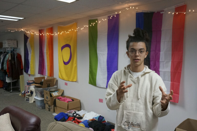 Sean Fisher, one of the student coordinators for QPLUS, the LGBTQ student organization for the College of Saint Benedict and Saint John's University, stands in the organization's dedicated lounge on the college's campus in St. Joseph, Minn., on Tuesday, Nov. 8, 2022. To Fisher, a senior in environmental studies who identifies as non-binary, the Catholic colleges' recognition and funding of the organization represents a new era. (AP Photo/Giovanna Dell'Orto)