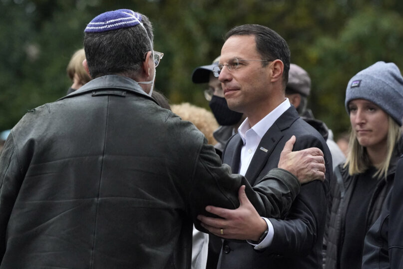 FILE - Pennsylvania Attorney General Josh Shapiro, center, attends a Commemoration Ceremony in Schenley Park, in Pittsburgh's Squirrel Hill neighborhood, on Wednesday, Oct. 27, 2021, three years after a gunman killed 11 worshippers at the Tree of Life Synagogue. Shapiro will be taking office as Pennsylvania's next governor in January 2023 after running a campaign in which he spoke early and often about his Jewish religious heritage. (AP Photo/Gene J. Puskar, File)