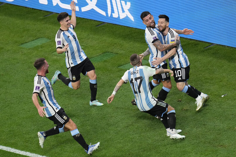 Argentina's Lionel Messi, right, celebrates with teammates after scoring the opening goal during the World Cup round of 16 soccer match between Argentina and Australia at the Ahmad Bin Ali Stadium in Doha, Qatar, Saturday, Dec. 3, 2022. (AP Photo/Manu Fernandez)