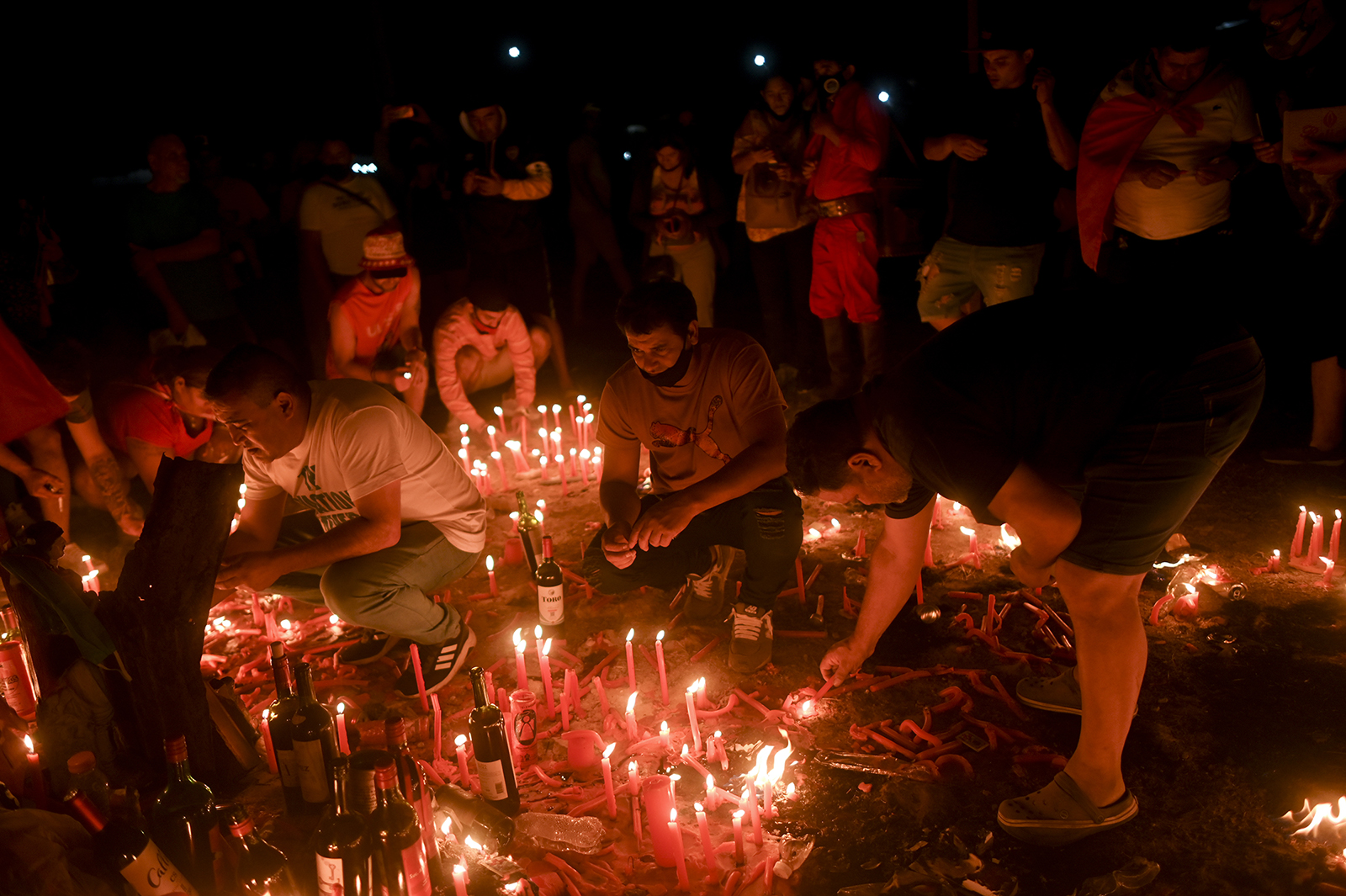 Pilgrims light candles to mark the death anniversary of folk saint Gauchito Gil, in his sanctuary near Mercedes, Corrientes, Argentina, on Jan. 8, 2022. (AP Photo/Mario De Fina)