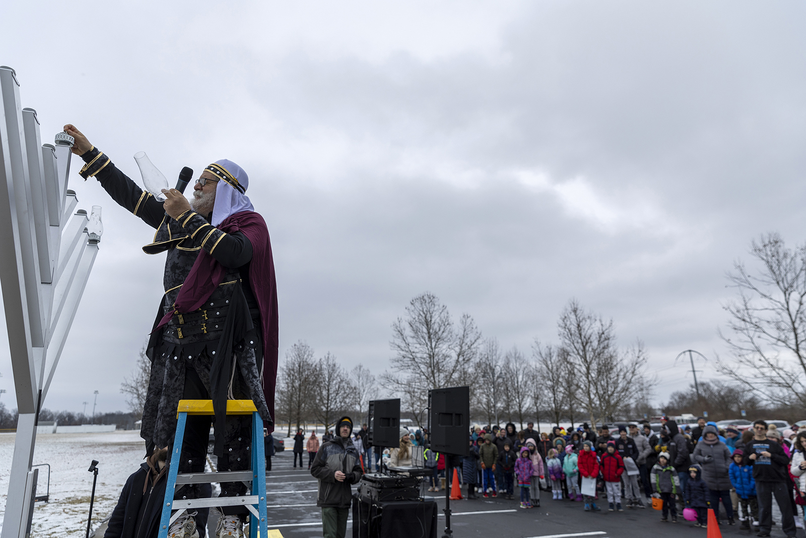 Rabbi Areyah Kaltmann of Columbus, Ohio, lights the menorah in Bevelhymer Park on Dec. 18, 2022. Kaltmann is dressed as Judah Macabee, the hero of the Hanukkah story. Photo by Harry Acosta Photography