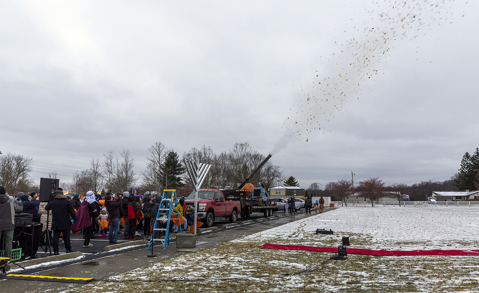 A candy cannon is shot from a flatbed trailer in Bevelhymer Park on Dec. 18, 2022, during events for the start of Hanukkah in Columbus, Ohio. Photo by Harry Acosta Photography