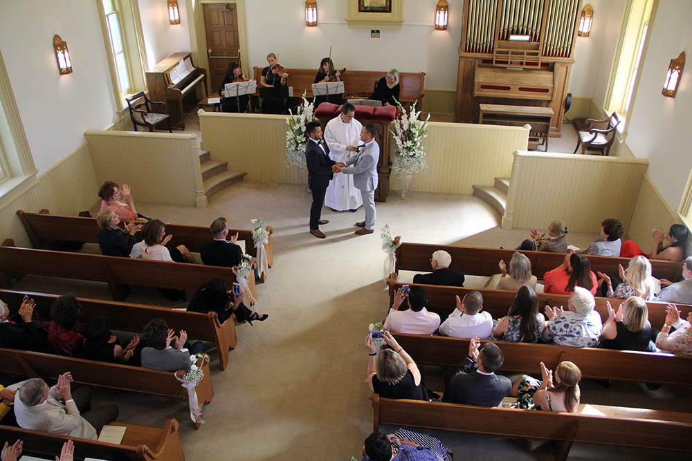 Eduardo Ramirez, left, and Randall Thacker exchange vows at their wedding in a historic LDS Church on Capital Hill in Salt Lake City in Sept. 2018. Photo courtesy of Thacker