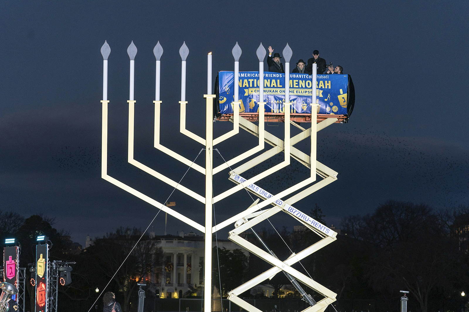 From left, Rabbi Levi Shemtov, Rabbi Abraham Shemtov and Attorney General Merrick Garland participate in the annual National Menorah Lighting in celebration of Hanukkah, on the Ellipse near the White House in Washington, Sunday, Dec. 18, 2022. (AP Photo/Jose Luis Magana)