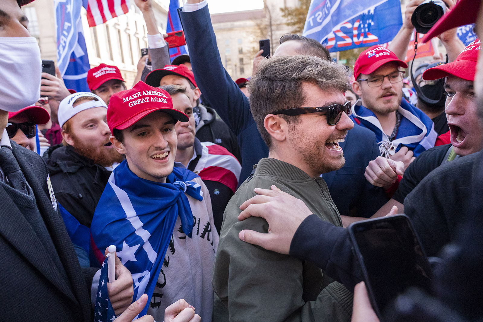 Nick Fuentes, center right in sunglasses, greets supporters before speaking at a pro-Trump march, Nov. 14, 2020, in Washington. Former President Donald Trump had dinner Nov. 22, 2022, at his Mar-a-Lago club with the rapper formerly known as Kanye West, who is now known as Ye, as well as Fuentes, who has used his online platform to spew antisemitic and white supremacist rhetoric.(AP Photo/Jacquelyn Martin, File)