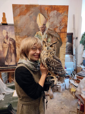 Artist Natalia Tsarkova holds her owl, Rufus Majestic, at her studio in Rome in early Dec. 2022. RNS photo by Claire Giangravé
