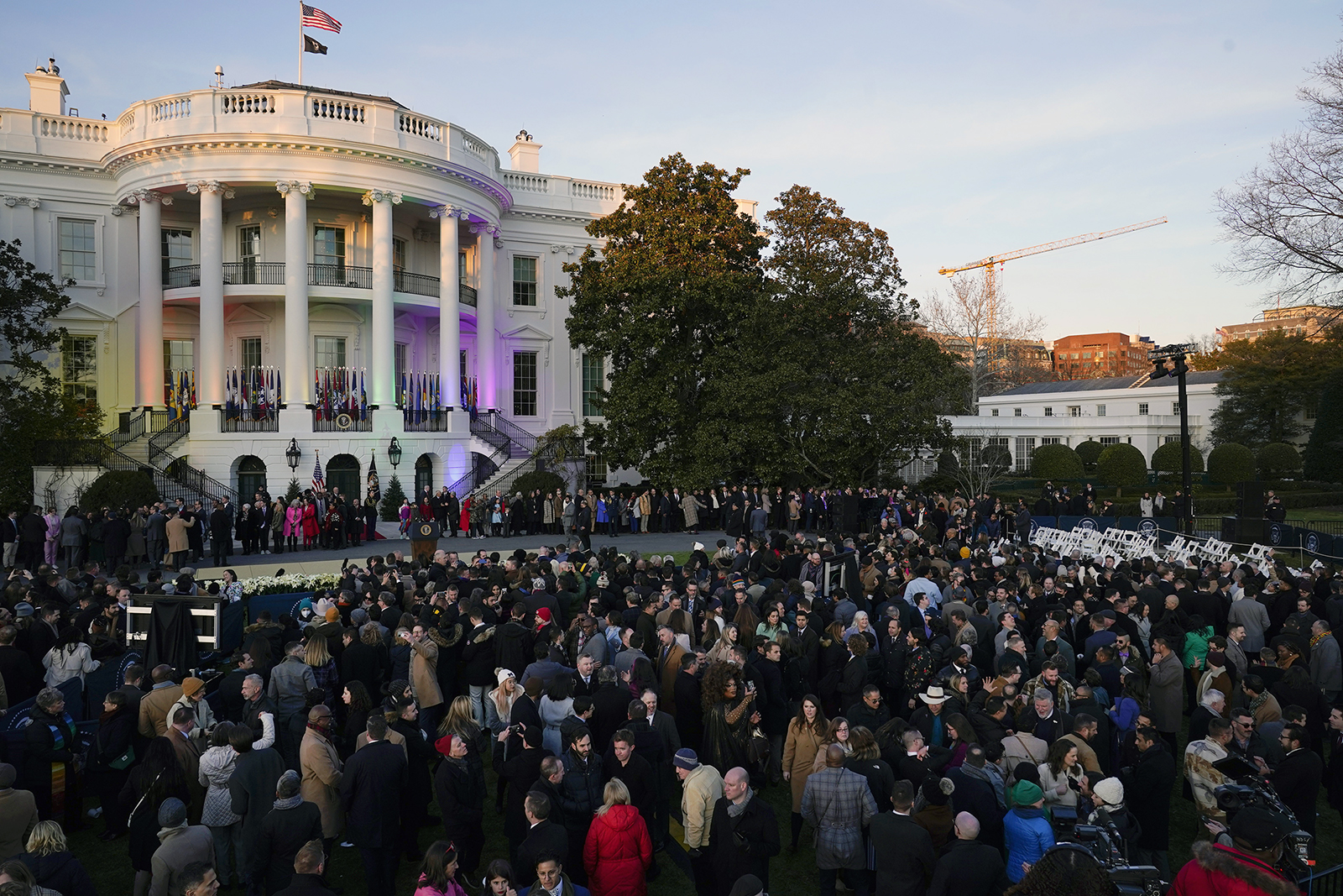 People mingle on the South Lawn after President Joe Biden signed the Respect for Marriage Act, Tuesday, Dec. 13, 2022, at the White House in Washington. (AP Photo/Andrew Harnik)