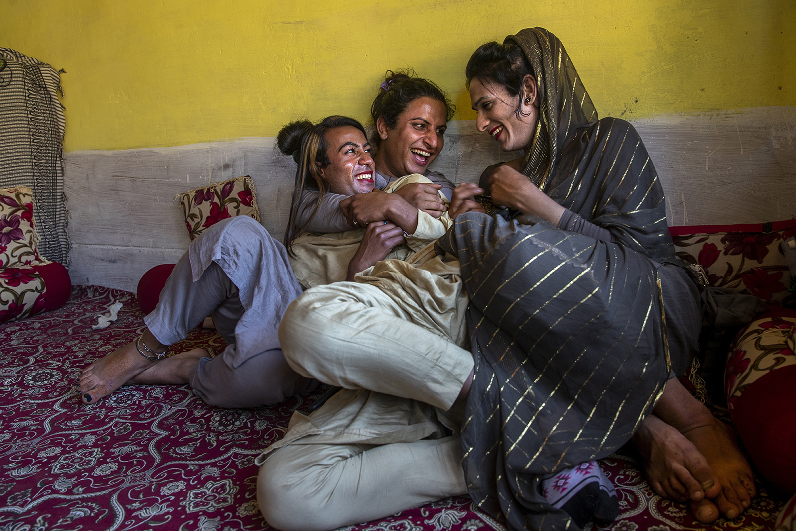 Khushi Mir, left, a transgender Kashmiri, relaxes with friends after a meeting of community members in the outskirts of Srinagar, Indian controlled Kashmir, on June 4, 2021. Mir and four others created a volunteer group to distribute food. They provided ration kits for hundreds of people, many of them makeup artists, singers and matchmakers who have lost their livelihoods during the pandemic. (AP Photo/Dar Yasin)