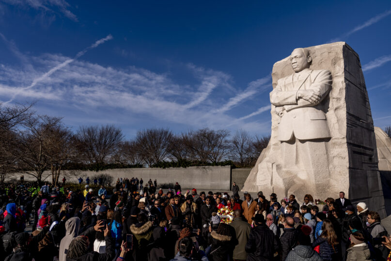 A large group gathers to watch a wreath-laying ceremony at the Martin Luther King Jr. Memorial on Martin Luther King Jr. Day in Washington, Jan. 16, 2023. (AP Photo/Andrew Harnik)