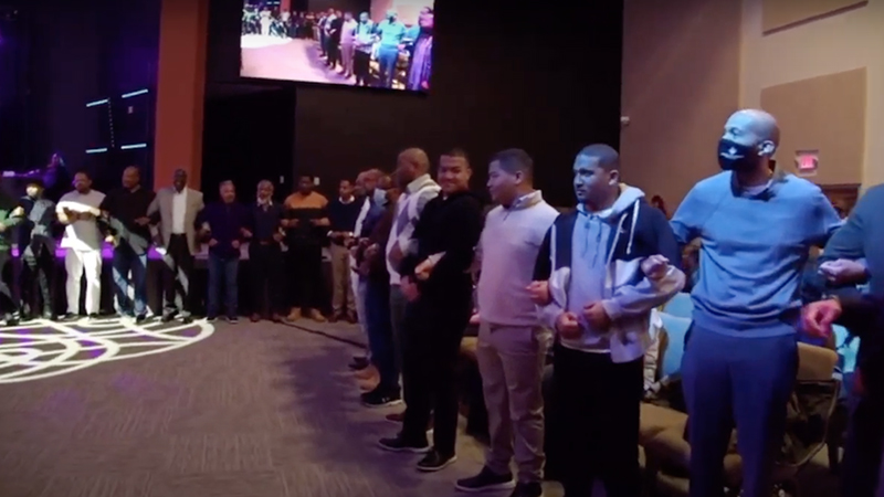 Males join arms and recite the “Brotherhood Creed" at Destiny World Church in the Atlanta suburb of Austell, Georgia, Sunday, Jan. 29, 2023. Video screen grab