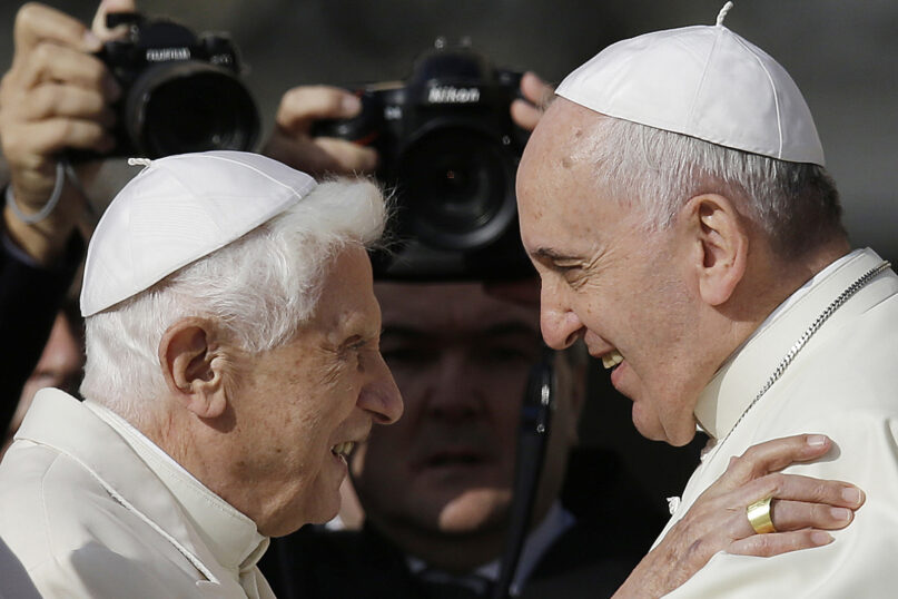 FILE - In this Sunday, Sept. 28, 2014 file photo, Pope Francis, right, hugs Emeritus Pope Benedict XVI prior to the start of a meeting with elderly faithful in St. Peter's Square at the Vatican. (AP Photo/Gregorio Borgia, File)
