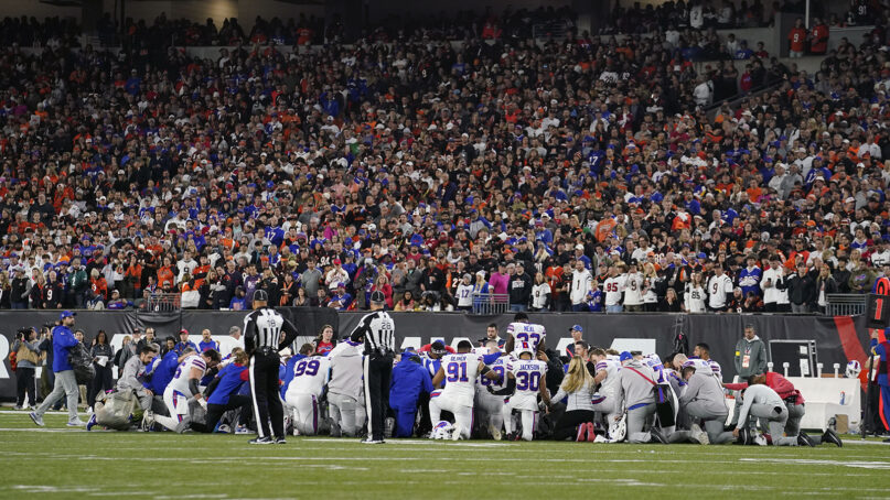 Buffalo Bills players pray for teammate Damar Hamlin during the first half of an NFL football game against the Cincinnati Bengals, Jan. 2, 2023, in Cincinnati. (AP Photo/Jeff Dean)