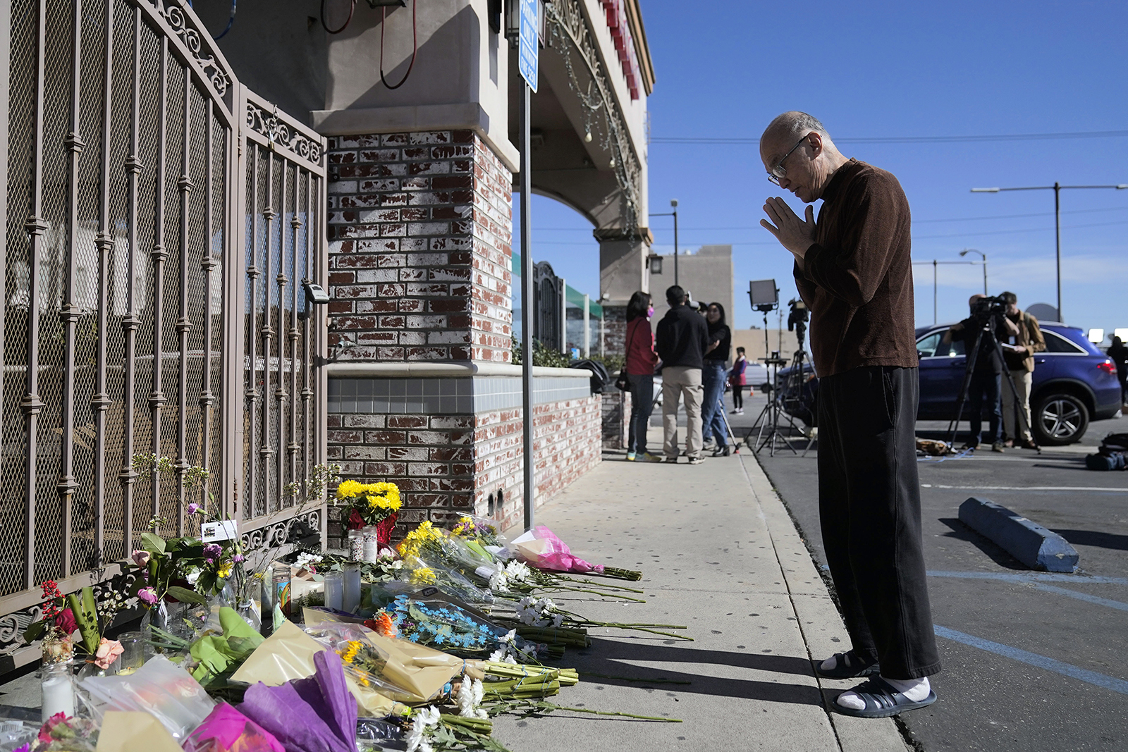 Kenny Loo, 71, prays outside Star Ballroom Dance Studio on Jan. 23, 2023, for the victims killed two days before in the shooting in Monterey Park, California. Authorities searched for a motive for the gunman who killed multiple people at the ballroom dance studio during Lunar New Year celebrations, slayings that sent a wave of fear through Asian American communities and cast a shadow over festivities nationwide. (AP Photo/Jae C. Hong)