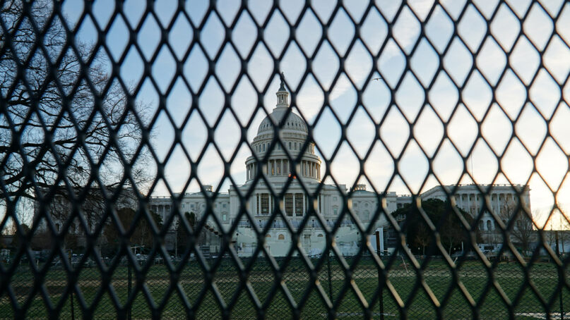 The U.S. Capitol behind security fencing in Washington, D.C. Photo by Ian Hutchinson/Unsplash/Creative Commons