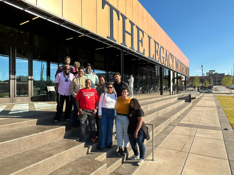 A racial justice pilgrimage to the American South brought together a group of Jews of color who traveled to key civil rights sites in Georgia and Alabama in October 2022. The group is pictured beside the Legacy Museum in Montgomery, Alabama, which displays the history of slavery and racism in America.  Photo courtesy of Reconstructing Judaism