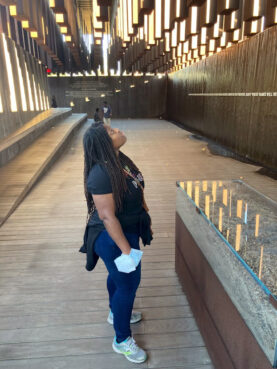 Lazora Jordan, a member of Reconstructing Judaism's Jews of Color and Allies Advisory Group, looks up at an installation to the victims of lynching at the National Memorial for Peace and Justice in Montgomery, Alabama, in Oct. 2022. Photo courtesy Reconstructing Judaism