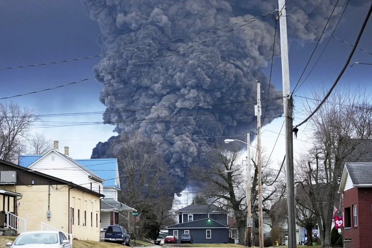 A plume of black smoke, from a controlled explosion of the derailed train, rises over East Palestine, Ohio. Credit: Gene J. Puskar, AP Images