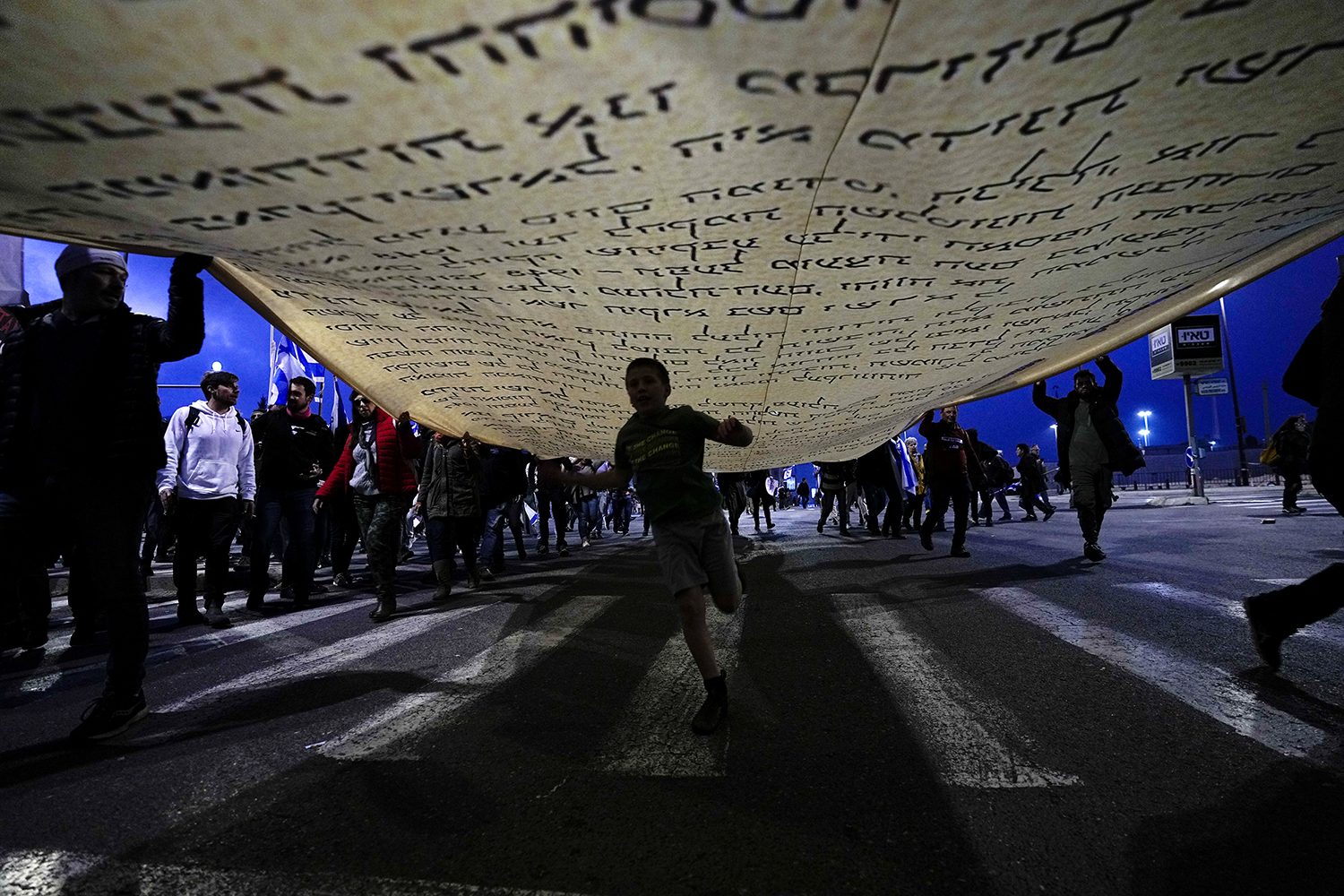 Protesters carry a large copy of the Israeli Declaration of Independence during a protest Feb. 20, 2023, near the Knesset, Israel’s parliament, in Jerusalem. Demonstrators oppose plans by Prime Minister Benjamin Netanyahu’s new government to overhaul the judicial system. (AP Photo/Ohad Zwigenberg)