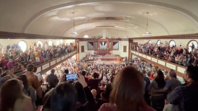 People attend a revival in Hughes Memorial Auditorium on the campus of Asbury University in Wilmore, Kentucky. Video screen grab