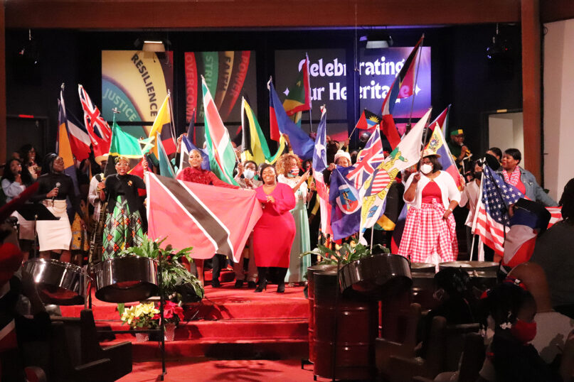 Flag bearers representing different countries stand at the front of Metropolitan Seventh-day Adventist Church after processing into the sanctuary for “Caribbean Sabbath” at the Hyattsville, Maryland, church on Feb. 18, 2023. RNS photo by Adelle M. Banks