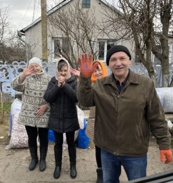 Aid recipients wave as Ken Ward leaves Pervomayskoe Village on Jan. 19, 2023, in Ukraine. Photo courtesy of Ward
