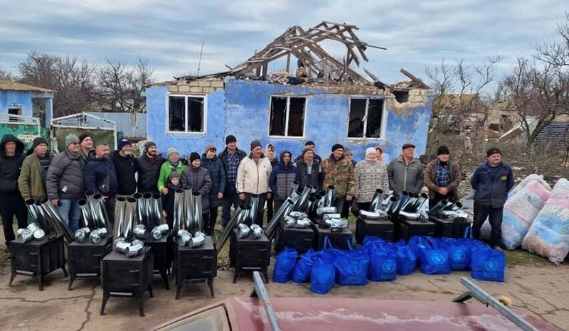 Ken Ward and volunteers pose together before distributing blankets and wood-burning stoves in Ukraine. Courtesy photo
