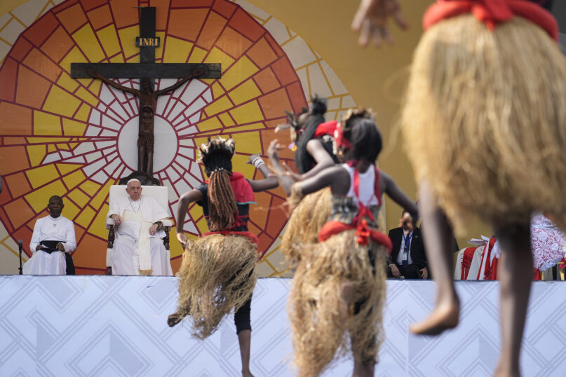 Pope Francis, second from left, watches traditional dancers perform at the Martyrs' Stadium in Kinshasa, Democratic Republic of the Congo, Thursday, Feb. 2, 2023. Francis was in Congo and South Sudan for a six-day trip, hoping to bring comfort and encouragement to two countries that have been riven by poverty, conflicts and what he calls a 