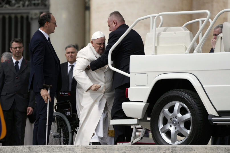 Pope Francis is helped to his car at the end of his weekly general audience in St. Peter's Square, at the Vatican, March 29, 2023. Francis went to a Rome hospital on Wednesday for tests, slipping out of the Vatican after his general audience and before the busy start of Holy Week this Sunday. (AP Photo/Alessandra Tarantino)