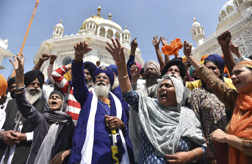 Supporters of the organization Waris Punjab De shout slogans in support of their chief and separatist leader Amritpal Singh and other arrested activists during a meeting at the Akal Takht Secretariat inside Golden Temple complex, in Amritsar, India, Monday, March 27, 2023. Indian police are searching for Amritpal Singh. (AP Photo/Prabhjot Gill)