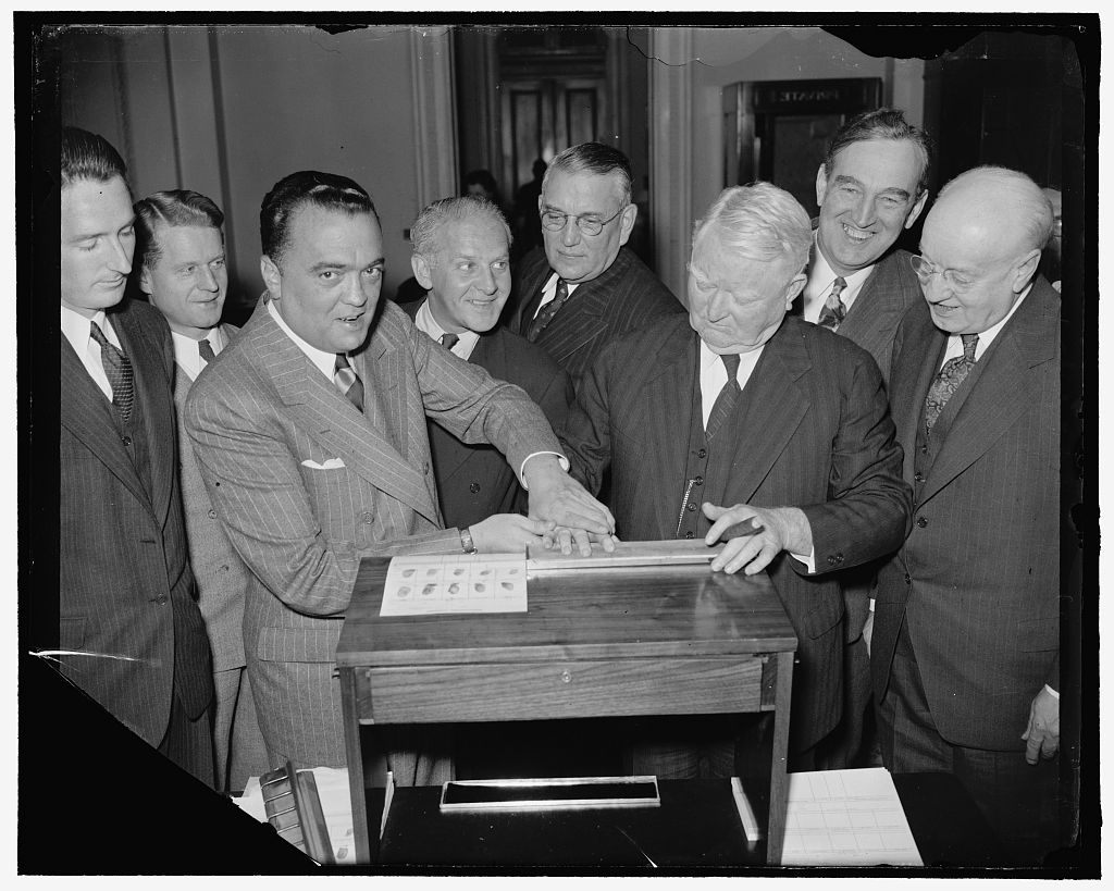 J. Edgar Hoover, left, fingerprints Vice President John N. Garner, circa 1939. Photo courtesy of Library of Congress/Creative Commons