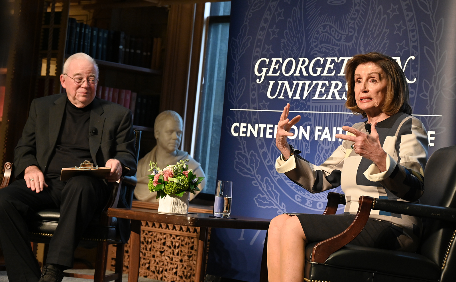 Former House Speaker Nancy Pelosi, right, speaks at Georgetown University’s Center on Faith and Justice with Jim Wallis, left, Thursday, March 23, 2023, in Washington. RNS photo by Jack Jenkins