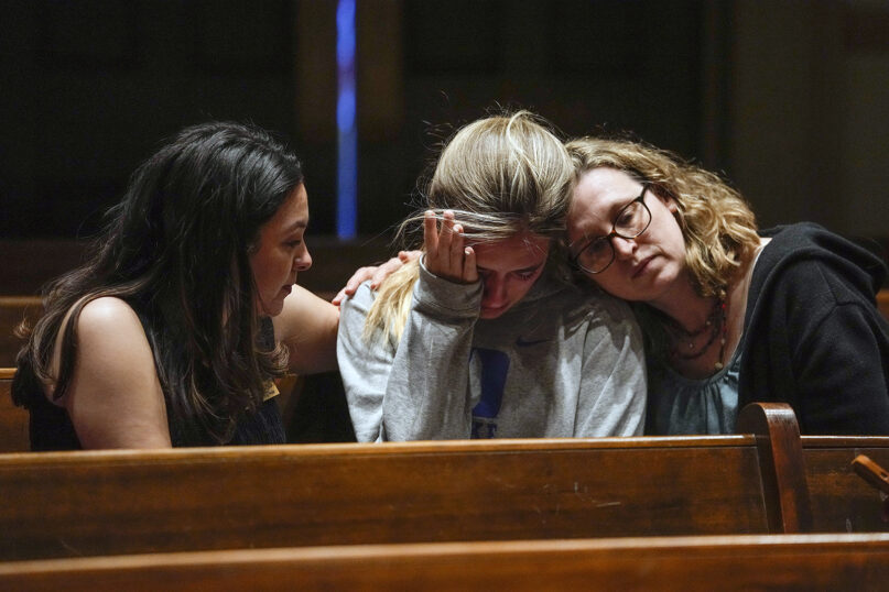 People participate in a community vigil at Belmont United Methodist Church in the aftermath of the school shooting March 27, 2023, in Nashville, Tennessee. Nashville police identified the victims in the private Christian school shooting Monday as three 9-year-old students and three adults in their 60s, including the head of the school. (AP Photo/John Bazemore)