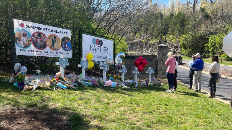 People pay respects at a memorial for the six people who were killed by a shooter, at an entry to The Covenant School, March 29, 2023, in Nashville, Tennessee. RNS photo by Bob Smietana