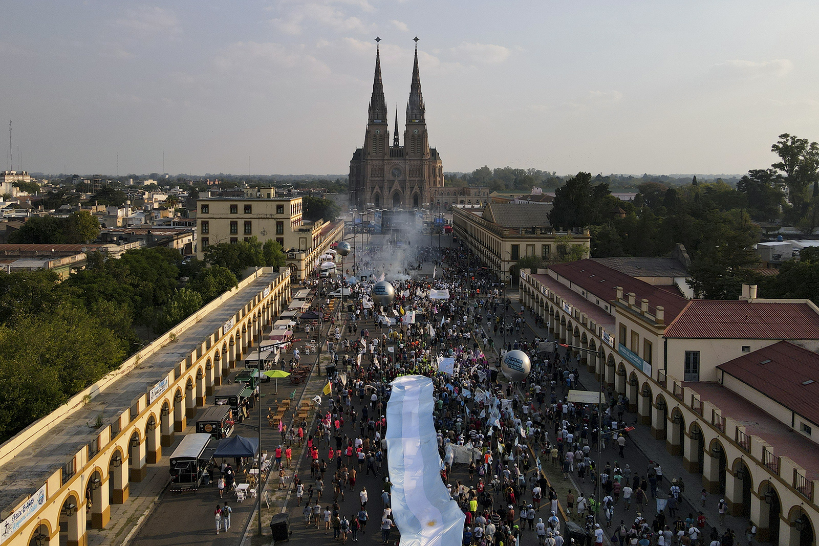 Faithful walk towards the Cathedral to attend a Mass celebrating 15 years of the Familia Grande Hogar de Cristo organization that works to rehabilitate drug addicts and marking Pope Francis' 10 year anniversary as Pope, in Lujan, Argentina, Saturday, March 11, 2023. (AP Photo/Natacha Pisarenko)