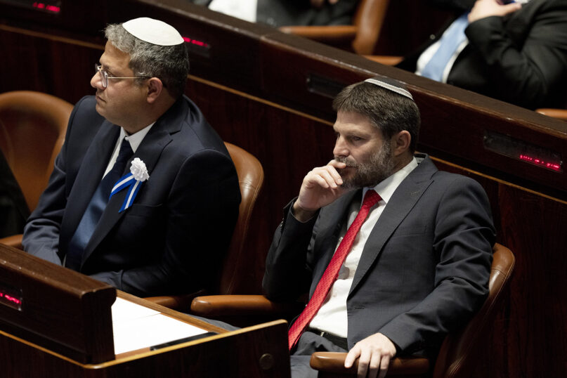 Far-right Israeli lawmakers Itamar Ben Gvir, left, and Bezalel Smotrich, right, attend the swearing-in ceremony for Israel's parliament, at the Knesset, in Jerusalem, Tuesday, Nov. 15, 2022. (AP Photo/ Maya Alleruzzo, Pool)