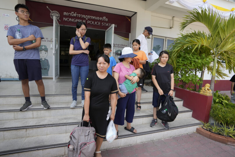 Members of the Shenzhen Holy Reformed Church, also known as the Mayflower Church, leave from the Nongprue police station on their way to Pattaya Provincial Court in Pattaya, Thailand, on March 31, 2023. More than 60 self-exiled members of a Chinese Christian church who were detained in Thailand after receiving U.N. refugee status will be deported by next week, probably to a third country, officials said Wednesday, April 5. (AP Photo/Sakchai Lalit)