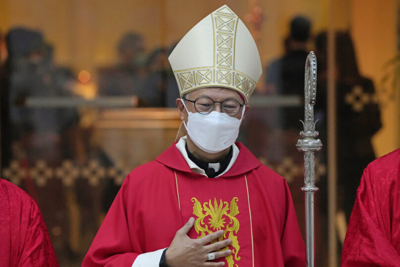 FILE - Stephen Chow wearing a surgical mask to protect against the coronavirus, poses after the episcopal ordination ceremony as the new Bishop of the Catholic Diocese, in Hong Kong, Dec. 4, 2021. The Hong Kong's Roman Catholic bishop arrived in Beijing on Monday, April 17, 2023, marking the first visit to the Chinese capital by the city's bishop in nearly three decades, despite signs of Sino-Vatican strains.(AP Photo/Kin Cheung, File)