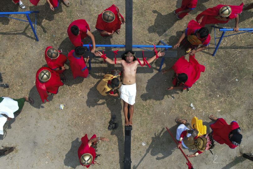 Ruben Enaje is nailed to the cross during a reenactment of Jesus Christ's sufferings as part of Good Friday rituals April 7, 2023, in the village of San Pedro, Cutud, Pampanga province, northern Philippines. The real-life crucifixions, a gory Good Friday tradition that is rejected by the Catholic church, resumes in this farming village after a three-year pause due to the coronavirus pandemic.(AP Photo/Aaron Favila)